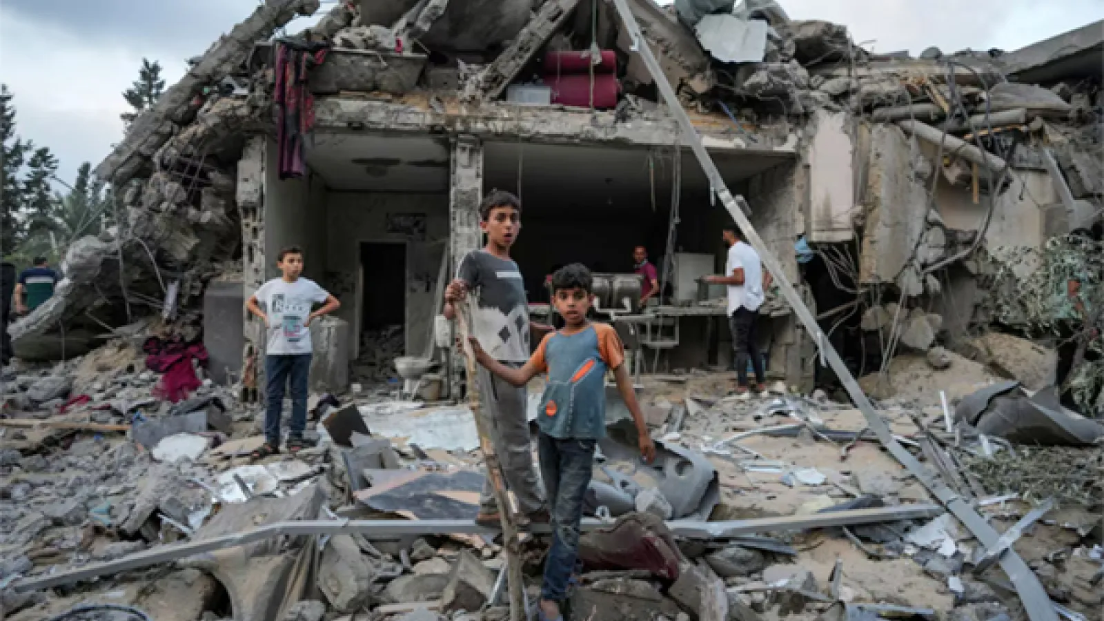 Palestinians look at the destruction after an Israeli airstrike in Deir al Balah, Gaza Strip, on April 30. (Abdel Kareem Hana/AP)
