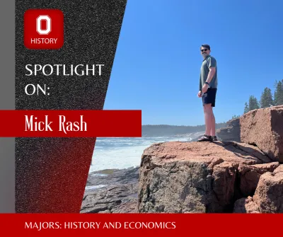 Mick Rash standing on a large rock overlooking the ocean