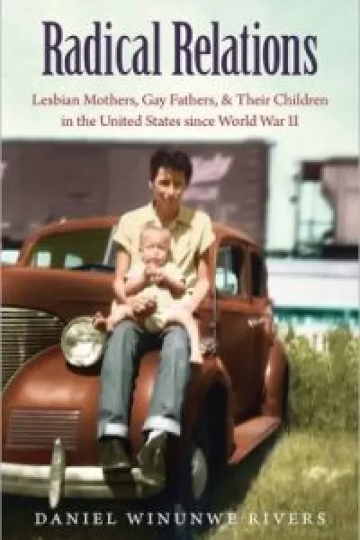 a person holding a small child and sitting on a car