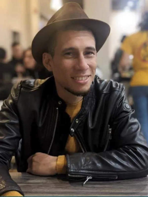Wearing dark brown jacket and hat with yellow sweater 